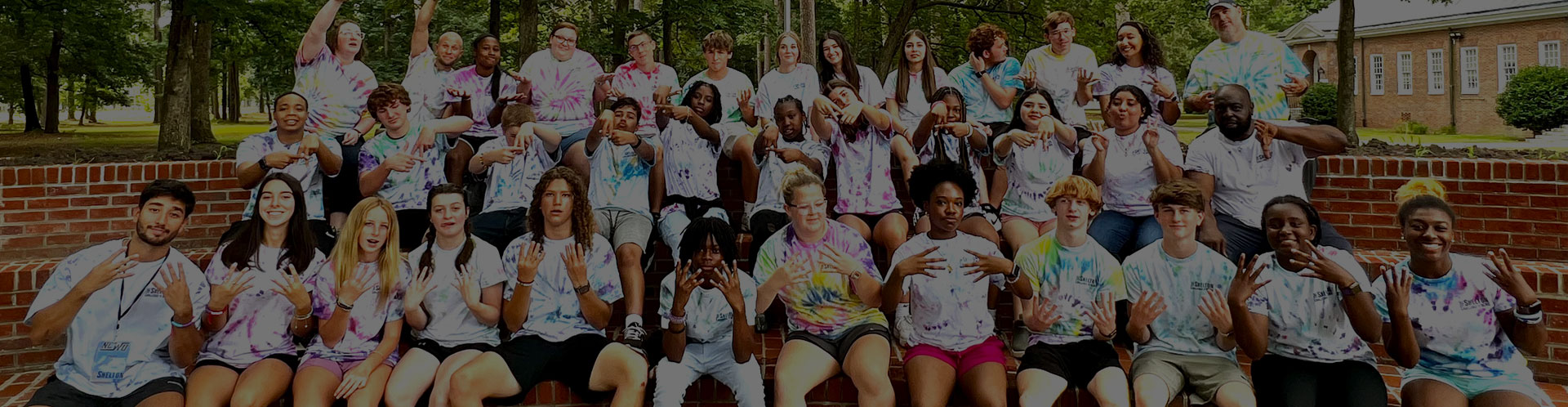 group of students sitting in outdoor classroom having fun