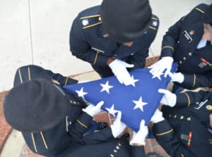 NCWC ROTC Students folding American flag during ceremony