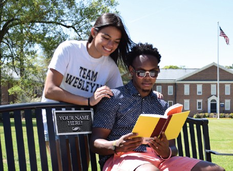 students reading on campus