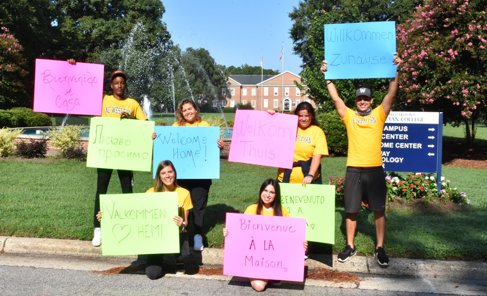 International Students holding welcome signs