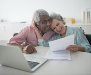 signing-documents senior ladies smiling, signing documents