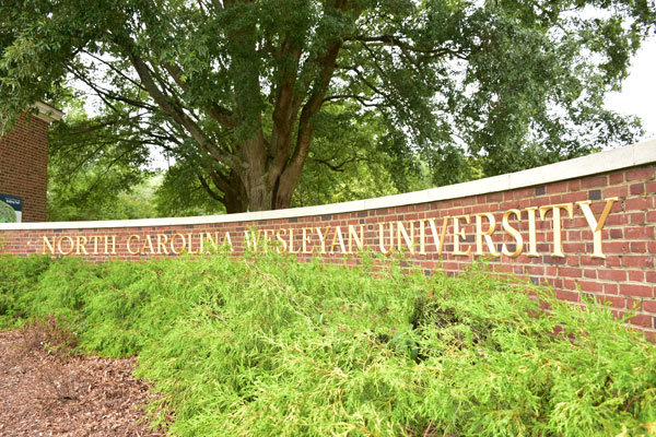 brick wall with NCWU letters