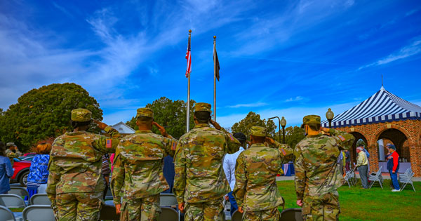 NCWU ROTC cadets stand and salute the flag