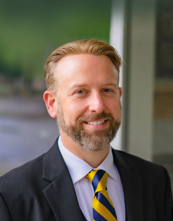 professional white male in suit, college president