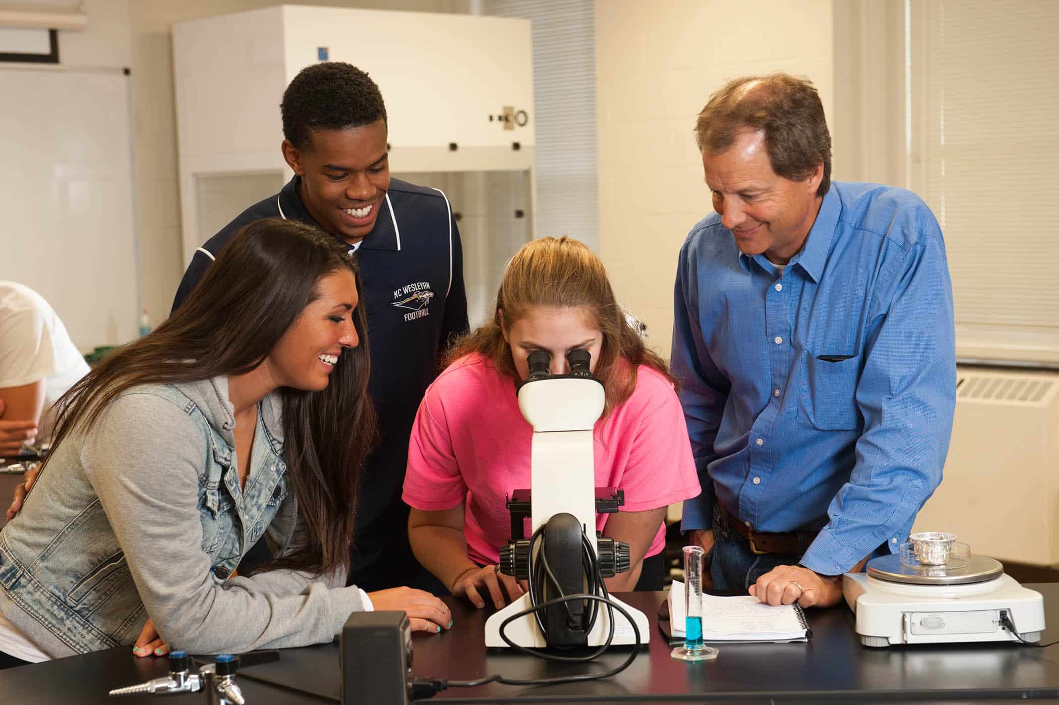 students looking through microscope NCWU