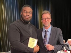 male political science student accepting award