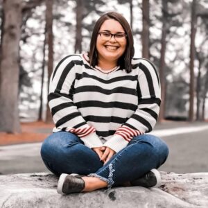 student sitting on rock