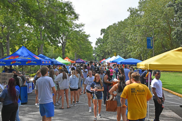 Students walk along Tyler Drive visiting vendors at the 2022 Rock the Mount event