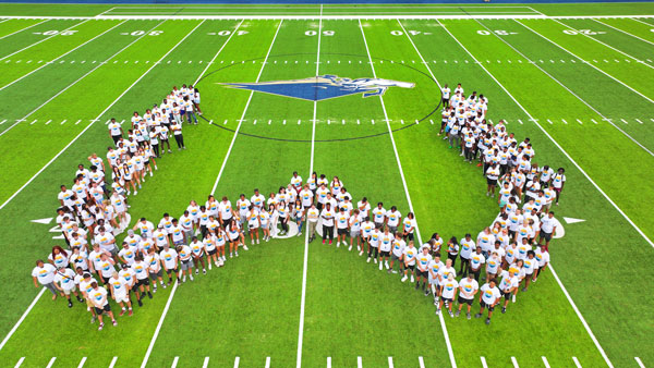 Freshman students form a large W on the turf field at NC Wesleyan