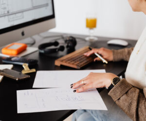 woman-reviewing-ira-plan-web woman looking over bills and retirement paperwork