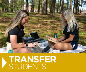 two white female students studying on lawn, North Carolina Wesleyan University